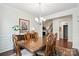 Spacious dining room with hardwood floors, stylish lighting, and convenient access to living spaces at 10120 Berkeley Castle Dr, Charlotte, NC 28273