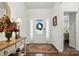 Bright entryway with a decorated glass-paneled door, hardwood floors, and stylish console table at 10120 Berkeley Castle Dr, Charlotte, NC 28273