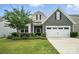 Charming home featuring a two-car garage and beautifully landscaped front yard at 10120 Berkeley Castle Dr, Charlotte, NC 28273