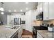 Well-lit kitchen boasts stainless appliances, granite countertops, and dark hardwood flooring at 10120 Berkeley Castle Dr, Charlotte, NC 28273