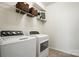 Bright laundry room with modern washer and dryer and shelving at 10120 Berkeley Castle Dr, Charlotte, NC 28273