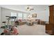 Large living room with neutral colors, carpeting, many windows, and a ceiling fan at 10120 Berkeley Castle Dr, Charlotte, NC 28273