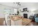 Cozy living room with a fireplace, hardwood floors, and comfortable seating arrangement at 10120 Berkeley Castle Dr, Charlotte, NC 28273