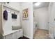 Mudroom with storage bench and hooks, leading to a laundry room with a washer and dryer at 10120 Berkeley Castle Dr, Charlotte, NC 28273