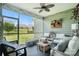 Inviting screened porch with comfortable seating, ceiling fan, and serene outdoor view at 10120 Berkeley Castle Dr, Charlotte, NC 28273