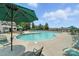 Large outdoor swimming pool with ample lounge chairs and umbrella tables for relaxation and enjoyment at 10120 Berkeley Castle Dr, Charlotte, NC 28273