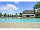 Large community pool with clear blue water, surrounded by comfortable lounge chairs and lush trees at 10120 Berkeley Castle Dr, Charlotte, NC 28273