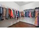 Spacious walk-in closet featuring ample storage space, hanging rods, and hardwood flooring at 10120 Berkeley Castle Dr, Charlotte, NC 28273