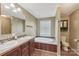 Bathroom with dual vanity, soaking tub, and wood-look floors at 1069 Heather Glen Dr, Catawba, NC 28609
