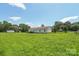 Expansive green backyard featuring a ranch-style home with a classic white exterior and fenced perimeter at 1069 Heather Glen Dr, Catawba, NC 28609