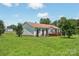 Side view of ranch style home with well-maintained lawn, trees and wooden fence at 1069 Heather Glen Dr, Catawba, NC 28609