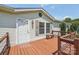 Welcoming covered front porch features wooden deck, railing, and charming white door at 1069 Heather Glen Dr, Catawba, NC 28609