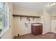 Laundry room featuring wood floors, wash sink, and overhead storage at 1069 Heather Glen Dr, Catawba, NC 28609
