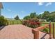 Red brick patio with a view of lush greenery, fencing, and a glimpse of neighboring houses at 1069 Heather Glen Dr, Catawba, NC 28609