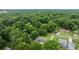 Wide angle aerial shot showing the home nestled in a neighborhood with mature trees and a lush green landscape at 115 Fox Run Dr, Fort Mill, SC 29715