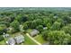 Aerial shot displays the home's location in a quiet, tree-filled neighborhood with well-maintained lawns at 115 Fox Run Dr, Fort Mill, SC 29715