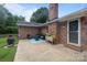 Comfortable back patio with brick chimney and outdoor seating at 115 Fox Run Dr, Fort Mill, SC 29715