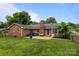 The backyard features a well manicured lawn, brick chimney, and outdoor seating at 115 Fox Run Dr, Fort Mill, SC 29715