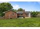 A great backyard featuring a well manicured lawn, brick chimney, and outdoor seating at 115 Fox Run Dr, Fort Mill, SC 29715