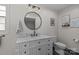 Updated bathroom with marble countertop, vanity, decorative mirror, and toilet at 115 Fox Run Dr, Fort Mill, SC 29715
