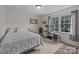 Bedroom with neutral walls, carpet flooring, and large window overlooking trees at 115 Fox Run Dr, Fort Mill, SC 29715
