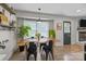 Dining room featuring a table and chairs with a view to the front yard and modern light fixture at 115 Fox Run Dr, Fort Mill, SC 29715