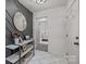 Stylish entryway showcasing modern decor, a round mirror, and open doorway to the bedroom at 115 Fox Run Dr, Fort Mill, SC 29715