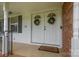 Elegant double front doors adorned with wreaths and a 'Welcome' mat, creating a warm entrance at 115 Fox Run Dr, Fort Mill, SC 29715