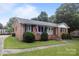 Charming brick home with landscaped front yard and covered porch at 115 Fox Run Dr, Fort Mill, SC 29715