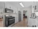 Updated kitchen featuring stainless steel appliances, and view to living spaces at 115 Fox Run Dr, Fort Mill, SC 29715