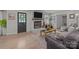 Bright living room featuring a charming fireplace, wooden floors, and outside access at 115 Fox Run Dr, Fort Mill, SC 29715