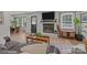 Cozy living room with fireplace, TV, and a view to the front yard with mature trees at 115 Fox Run Dr, Fort Mill, SC 29715
