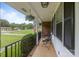 Inviting covered porch with cozy seating, fresh flowers, and an American flag on display at 115 Fox Run Dr, Fort Mill, SC 29715