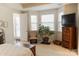 Bright bedroom with bay windows, comfortable seating and a beautiful decorative chest at 1156 Mckee Farm Ln, Belmont, NC 28012