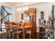 Elegant dining room featuring a wooden table and chairs, china cabinet, and wine storage at 1156 Mckee Farm Ln, Belmont, NC 28012