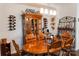Inviting dining area boasts wood floors, a spacious table, and a display cabinet with wine racks at 1156 Mckee Farm Ln, Belmont, NC 28012