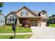 Inviting two-story home featuring a double garage, manicured lawn, and architectural details at 1156 Mckee Farm Ln, Belmont, NC 28012