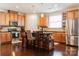 Bright kitchen features dark wood floors, cabinetry, an island with barstool seating, and stainless steel appliances at 1156 Mckee Farm Ln, Belmont, NC 28012