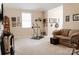 Cozy living area with comfortable sofa, exercise equipment, neutral colors and ample natural light at 1156 Mckee Farm Ln, Belmont, NC 28012