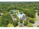 Overhead view of community amenities including tennis courts, a pool, clubhouse, and lush landscaping at 11724 Easthampton Cir, Charlotte, NC 28277