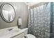 Bathroom featuring a vanity with ample storage and a shower with stylish curtain at 11724 Easthampton Cir, Charlotte, NC 28277
