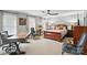 Spacious primary bedroom featuring a ceiling fan, natural light, and comfortable sitting area at 11724 Easthampton Cir, Charlotte, NC 28277
