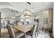 Dining room with modern chandelier and adjacent living room and kitchen at 11724 Easthampton Cir, Charlotte, NC 28277