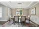 Traditional dining room with large window and stylish light fixture over the table at 11724 Easthampton Cir, Charlotte, NC 28277