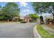 Gated community entrance featuring a brick guardhouse and beautifully landscaped surroundings at 11724 Easthampton Cir, Charlotte, NC 28277