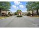 Welcoming gated community entrance with manicured landscaping, brick pillars and secure access at 11724 Easthampton Cir, Charlotte, NC 28277