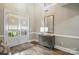 Bright entryway with double doors, hardwood floors, and a stylish console table with a mirror at 11724 Easthampton Cir, Charlotte, NC 28277