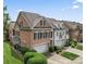 Aerial view of brick townhouses showing garages and manicured landscaping at 11724 Easthampton Cir, Charlotte, NC 28277