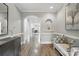 Elegant hallway with hardwood floors, detailed molding, and a decorative archway leading to the living area at 11724 Easthampton Cir, Charlotte, NC 28277
