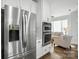 Modern kitchen featuring stainless steel appliances, double ovens, and an open view to the living area at 11724 Easthampton Cir, Charlotte, NC 28277